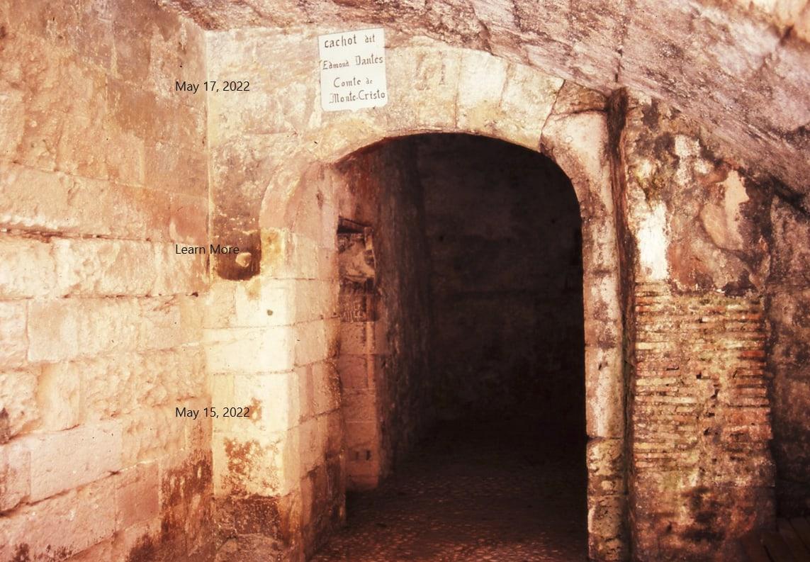 A bare stone cell with a small barred window, its walls worn by centuries of damp.
